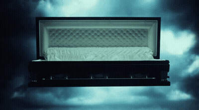 Black Coffin With Open Lid And White Blanket GIF