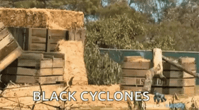 Black Cyclones Sign In Front Of Hay Pile GIF