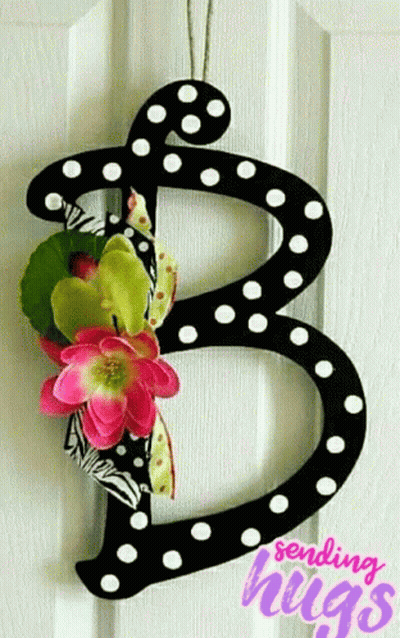 Black Letter B With White Polka Dots And Pink Flowers On Door GIF