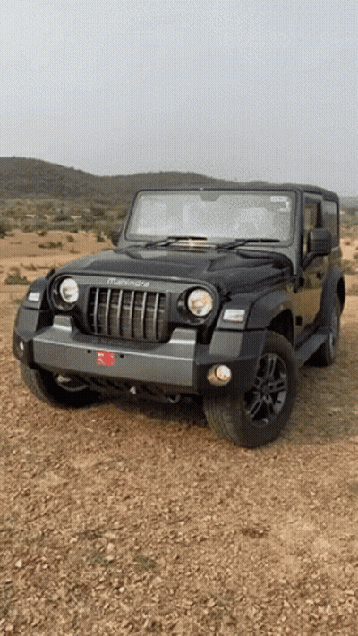 Black Mahindra Thar Jeep Parked On Dirt Field GIF