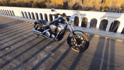 Black Motorcycle Parked On Roadside GIF