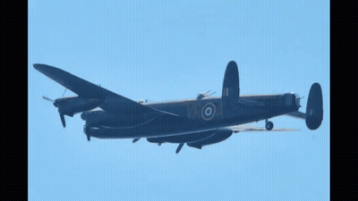 Black Plane With White Circle On Tail Flying In Blue Sky GIF