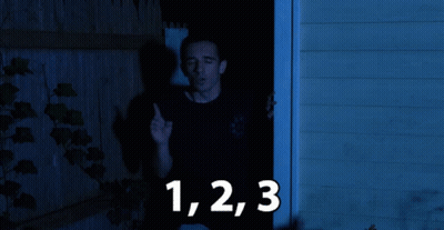 Black Shirt Man At Doorway With Numbers 1 2 3 GIF