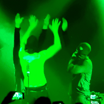 Black Shirt Man Dancing With Microphone Green Light GIF