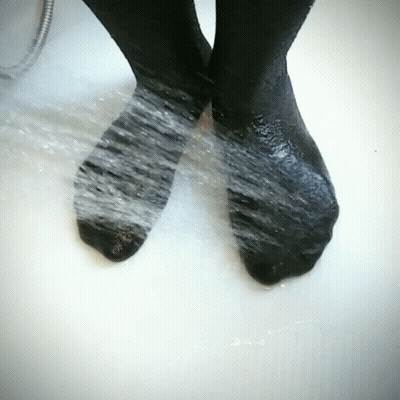 Black Socks Washed In Tub Of Water GIF