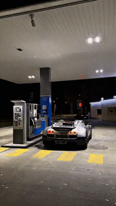 Black Sports Car Parked At Gas Station At Night GIF