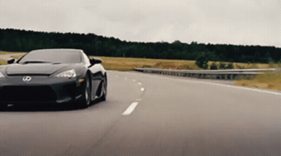 Black Sports Car With Letter S On Front Driving Down Highway GIF