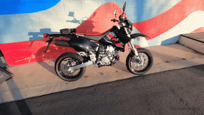 Black Suzuki Dirt Bike By Brick Wall GIF