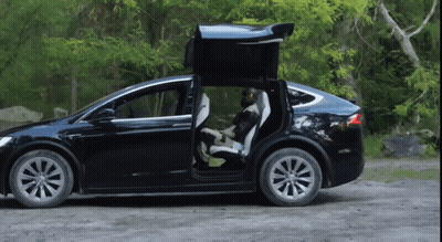 Black Tesla Model X Parked On Dirt Road With Doors Open GIF
