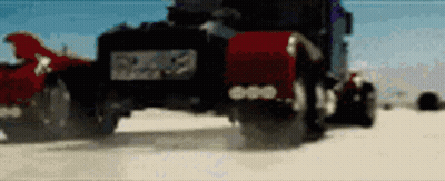 Black Truck With Red Hood Driving On Sandy Beach GIF