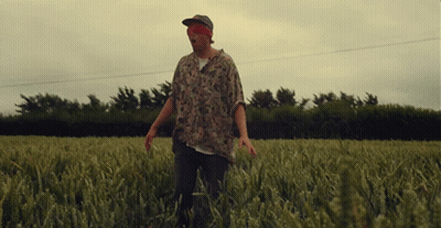 Blindfolded Man In Tall Grass GIF