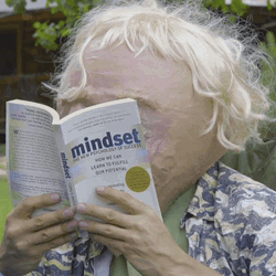Blonde Creature Laughing Reading Book  GIF