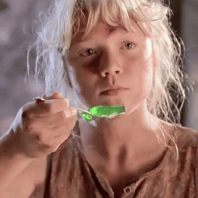 Blonde Girl Eating Green Jelly With Spoon GIF