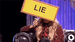 Blonde Girl Holding A Liar Card GIF