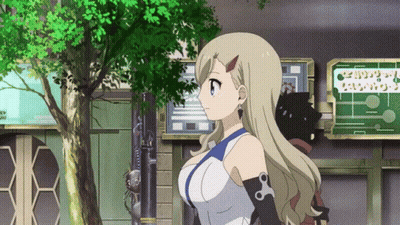 Blonde Girl In Front Of Building With I Love You Sign GIF