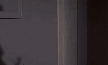 Blonde Girl Sneaks Through Door Opening GIF