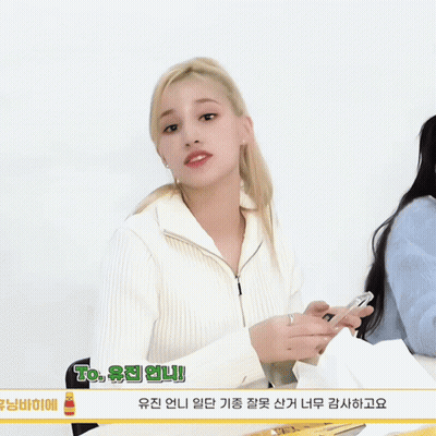 Blonde Girl With Ponytail Holding Perfume Saying To GIF