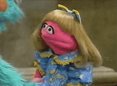 Blonde-Haired Pink Puppet In Blue Dress Next To Blue Puppet GIF