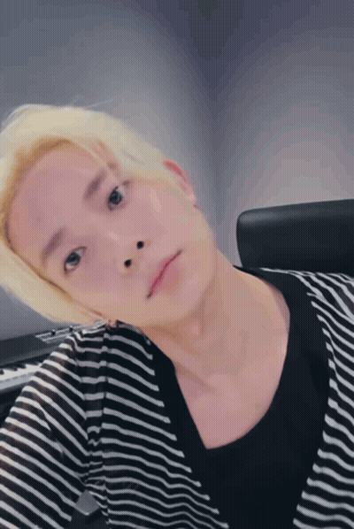 Blonde Man in Striped Shirt Taking Selfie