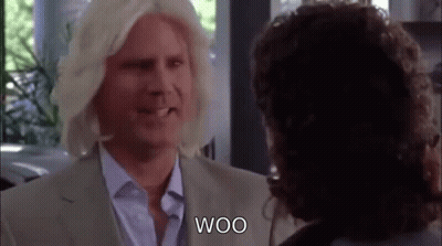 Blonde Man In Wig Talking To Another Man GIF