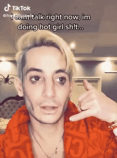 Blonde Man Red Jacket Making Call Me Sign GIF