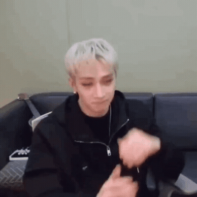 Blonde Man Sitting On Couch With Hands On Face GIF
