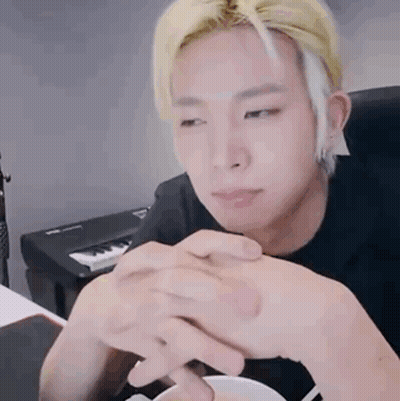 Blonde Man Sitting With Folded Hands GIF