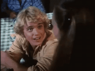 Blonde Man Smiling At Table With Woman GIF