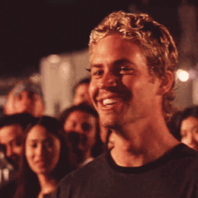 Blonde Man Smiling in Crowd