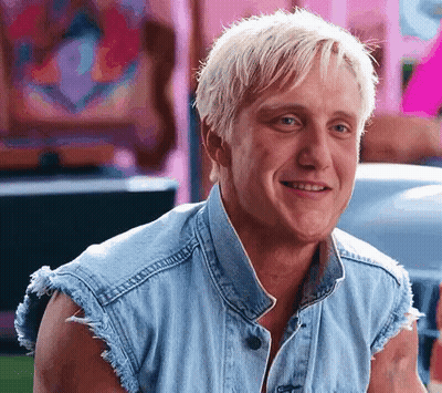 Blonde Man Smiling In Denim Vest GIF