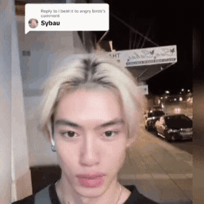 Blonde Man Standing In Front Of Building Looking At Camera GIF