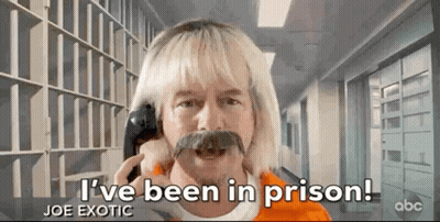 Blonde Man With Mustache Talking On Cell Phone In Prison GIF