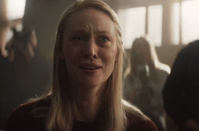 Blonde Woman Crying In Dark Crowd GIF