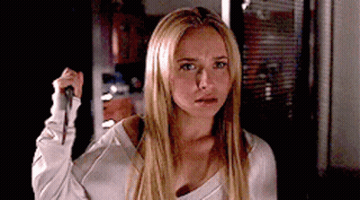 Blonde Woman Holding Knife In Dark Room GIF