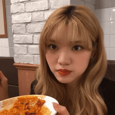 Blonde Woman Holding Plate of Food