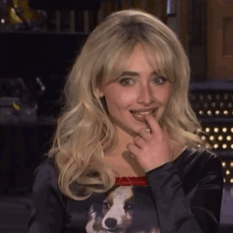 Blonde Woman In Black Dog Shirt Licking Lips GIF