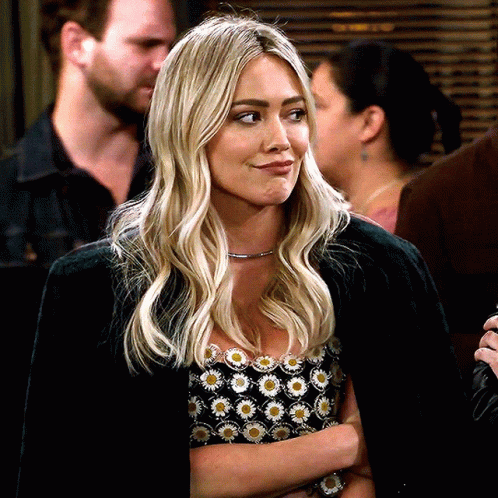 Blonde Woman In Black Jacket, Daisy Print Top GIF
