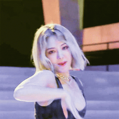 Blonde Woman In Black Tank Top And Gold Necklace GIF