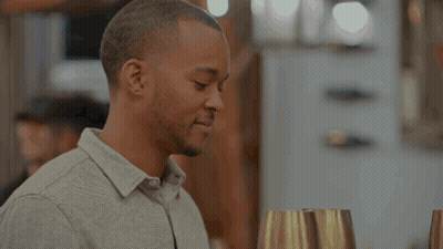 Blonde Woman In Black Top In Front Of Netflix Logo GIF
