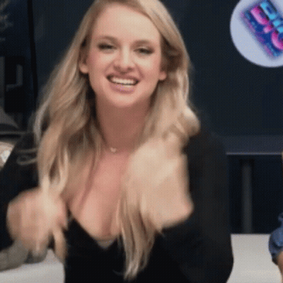 Blonde Woman In Black Top Smiling Holding Breasts GIF