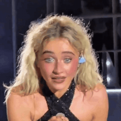 Blonde Woman In Black Top With Earrings GIF