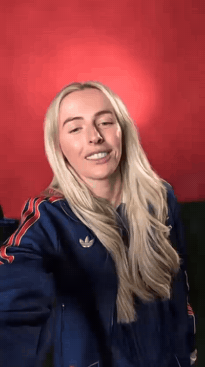Blonde Woman In Blue Adidas Jacket Making Funny Face GIF