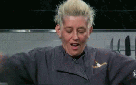 Blonde Woman In Blue Chef Jacket Making Funny Face GIF