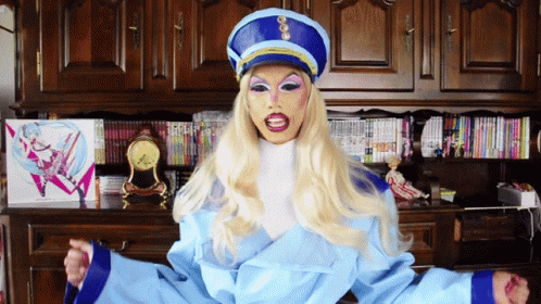 Blonde Woman In Blue Hat And Blue Jacket GIF
