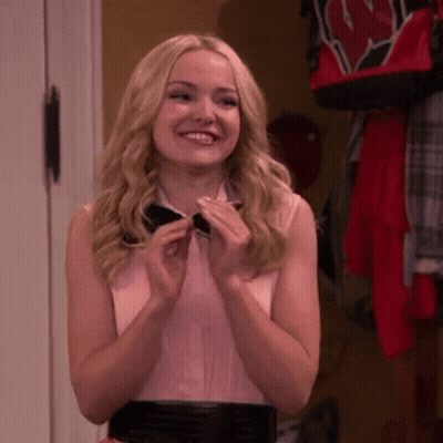 Blonde Woman In Bow Tie And Pink Shirt Smiles GIF