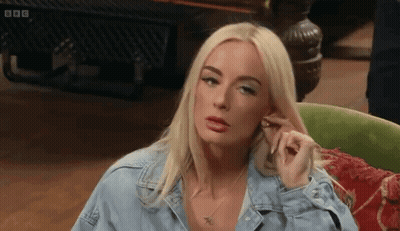 Blonde Woman In Denim Shirt Sitting In Green Chair GIF