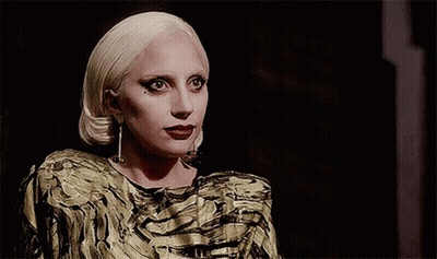 Blonde Woman In Gold And Black Dress GIF
