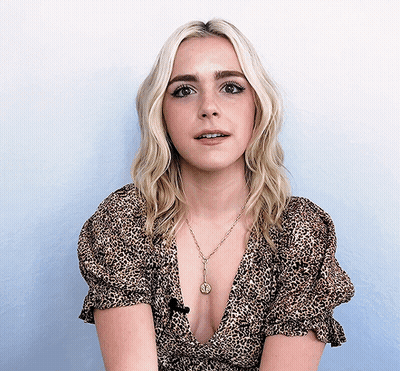 Blonde Woman In Leopard Top With Coin Necklace GIF