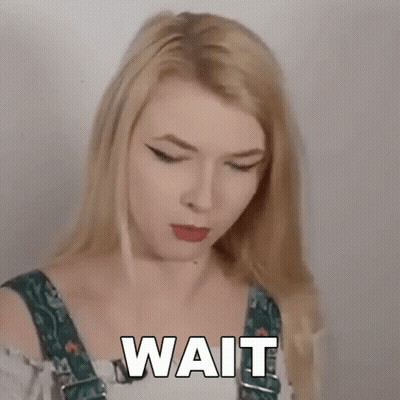 Blonde Woman In Overalls Making Funny Face Saying Wait GIF