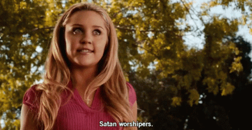 Blonde Woman in Pink Shirt Says Satan Worshipers